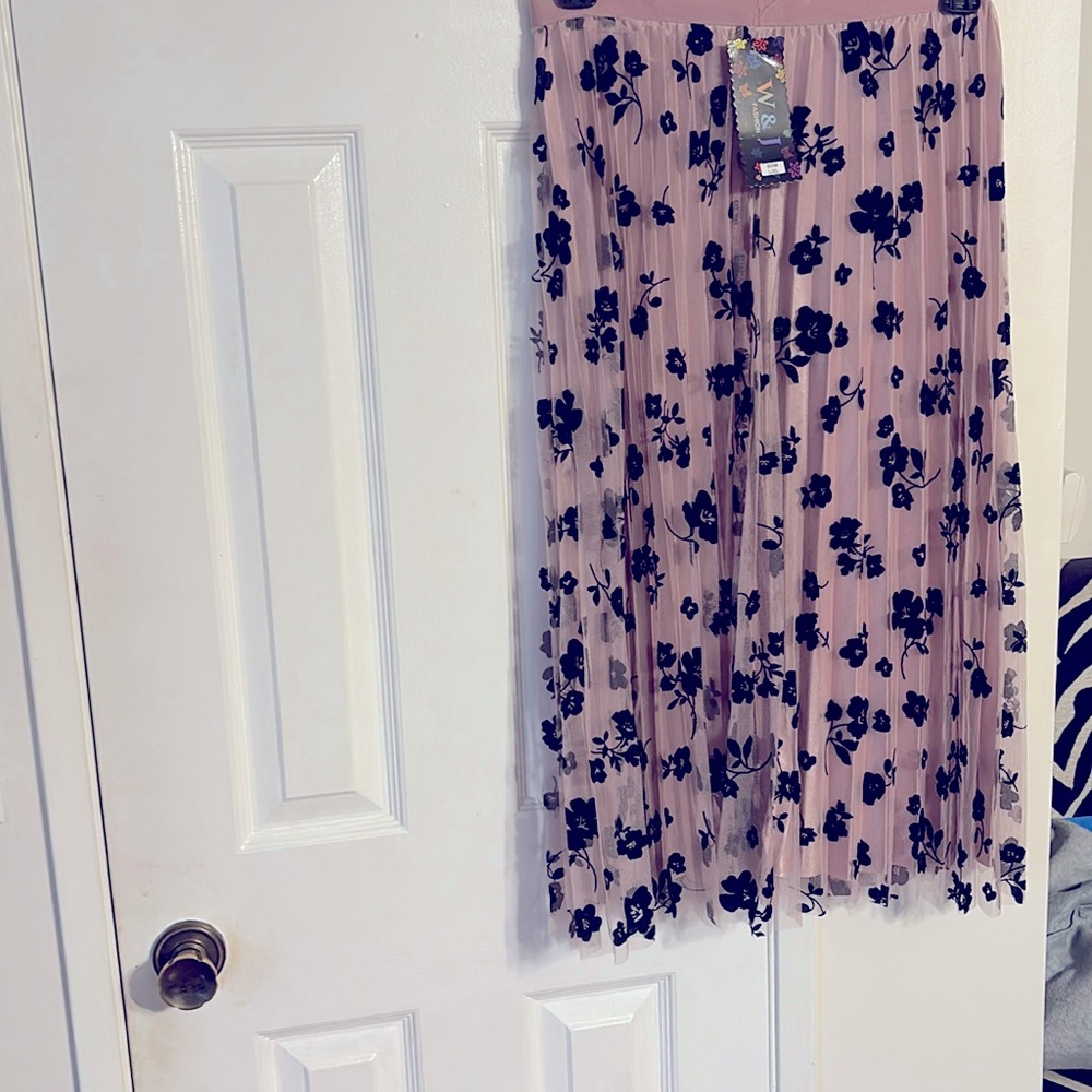 Pink pleated skirt with overlay sheer layer with black felt flowers